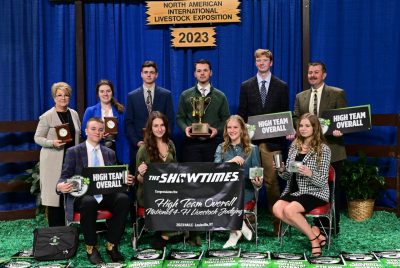 The national 4-H Livestock Judging Team winners sit in two rows, holding their awards for high team overall.