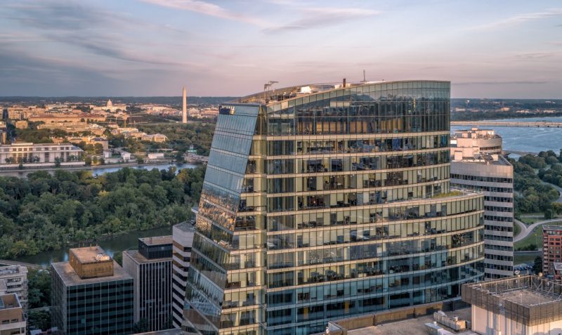photo of building taken by drone with DC in the background