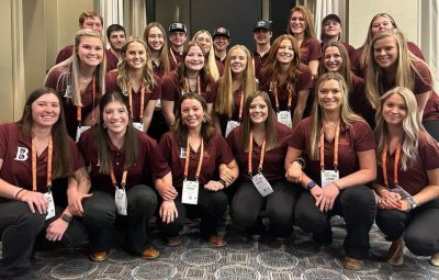 Group of Virginia Tech students from the Block & Bridle Club in maroon club polos and lanyards.