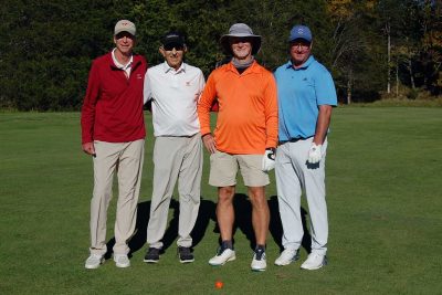 Team Biosystems, standing together, facing the camera on the golf course.