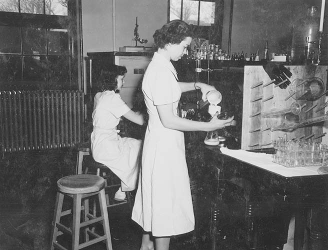 Females laboratory students making Newcastle serum in lab at VPI. 1950s. Special Collections.