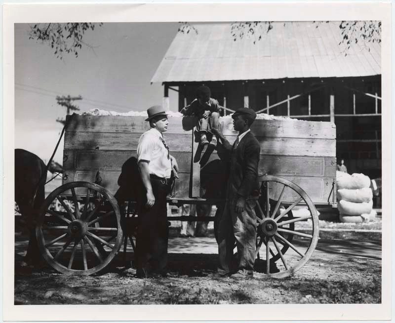 Men with horse-drawn wagon. A little boy sitting on top. No date given. Special Collections.