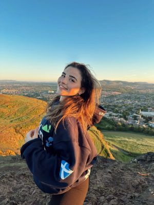 Cassie Borino standing at a high elevation and overlooking a town. 