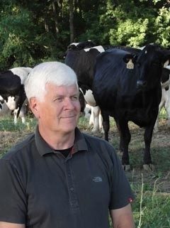 Dr. Robert James with dairy cows in the background.