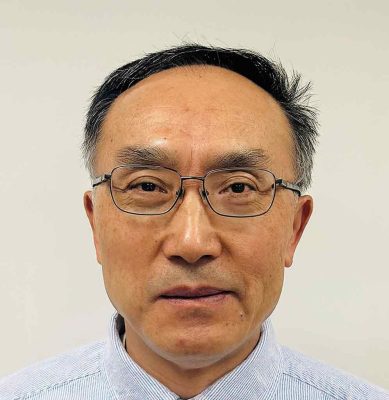 Dr. Honglin Jiang wearing glasses, looking toward the camera.