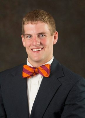 Photo of Adam Murray in a suit and orange and maroon Hokie bow tie.