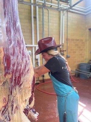 Student worker in cutting beef in the Virginia Tech Meat Center.