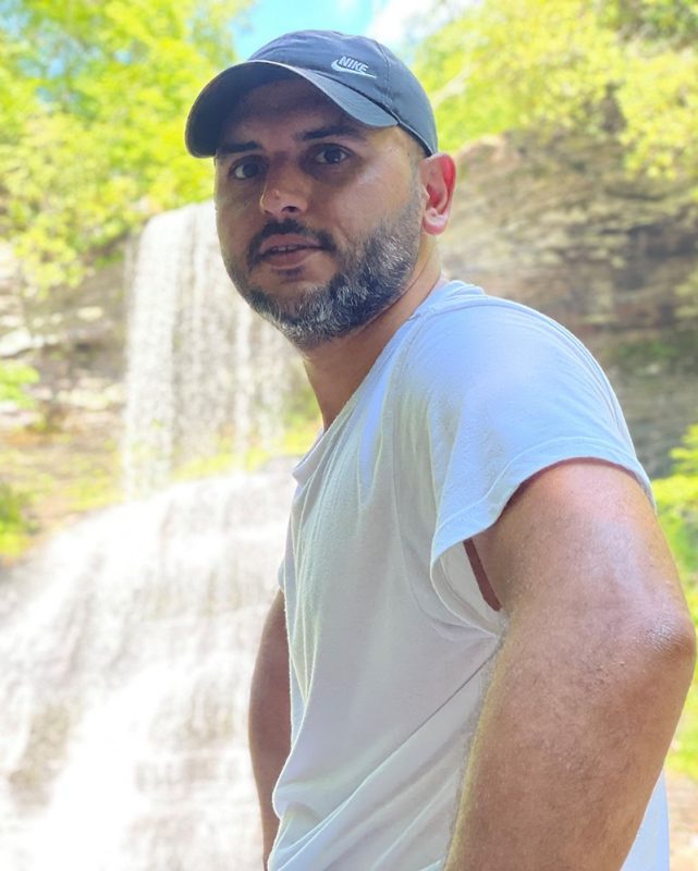 Photo of Kenan Aydin with the local Cascades waterfall in the background.